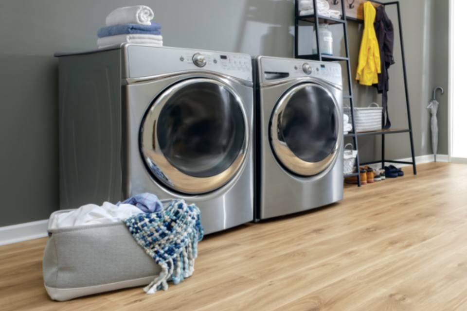 warm toned laminate flooring in laundry room.